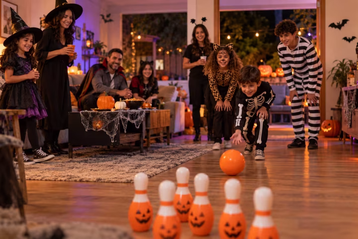 Children, teenagers, and adults playing Halloween party games at home
